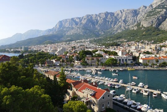 Makarska, Croatia. Coastal town, sea and mountains, Biokovo park. Aerial photography from a drone. Croatian town on the Adriatic Sea. Makarska Riviera