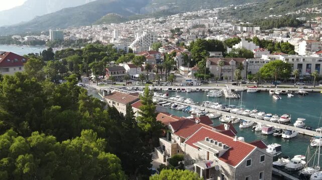 Makarska, Croatia. Coastal town, sea and mountains, Biokovo park. Aerial photography from a drone. Croatian town on the Adriatic Sea. Makarska Riviera
