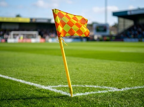 Bright corner kick flag on a vibrant green sports field