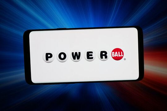 Stuttgart, Germany - 06-11-2026: In this photo illustration, the logo of US lottery game Powerball is displayed on a smartphone in front of abstract background on computer screen.