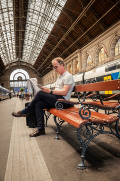 Mature businessman using tablet while waiting at railway station during travel