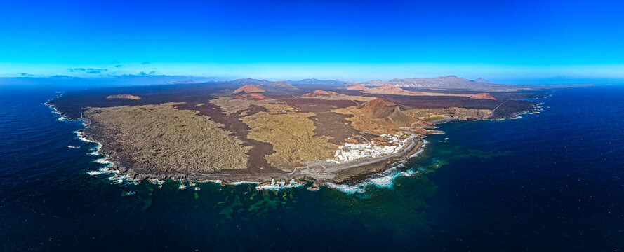 High Altitude Aerial View of Timanfaya National Park Badlands and Volcanic Coast at Sunset