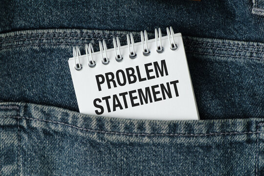 Notepad labeled Problem Statement rests in jeans pocket. Denim fabric shows wear, casual texture.