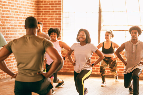 Group fitness class with diverse participants exercising