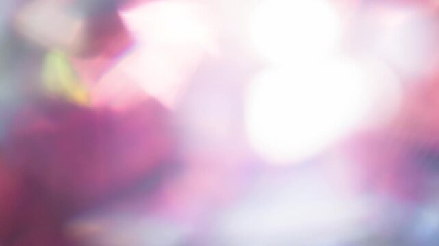 Pink Glints Through the Diamond Facets. Light passes through the facets of a slowly rotating faceted crystal, creating repeating sparkling reflections and iridescent colors