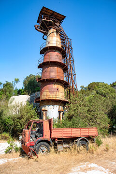 Rusty industrial tower abandoned in nature