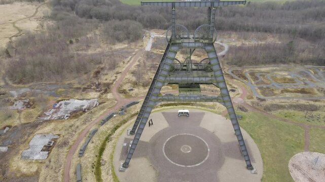 Aerial footage of old mining lift machinery A-frame