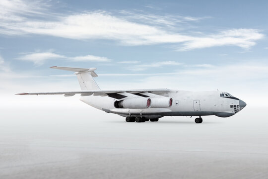 White big transport cargo aircraft isolated on bright background with sky