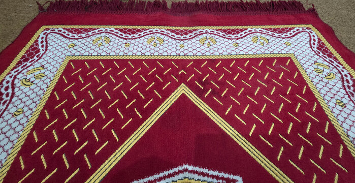 Close-up Textured Red and Gold Geometric Pattern on Fabric Background with Ornate Design
