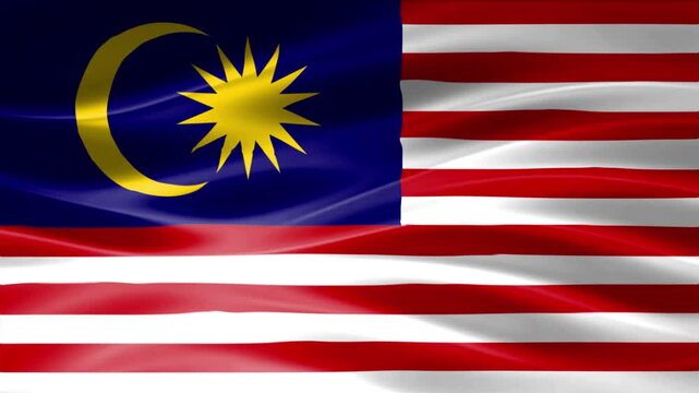 Flag of Malaysia waving in bright daylight with crescent moon and star symbol on blue field