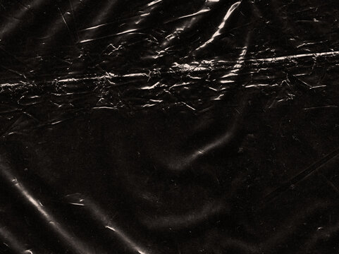 Dark abstract background featuring distressed scratches, subtle dust particles and vintage film texture details. Atmospheric black grunge surface with organic imperfections and cinematic character.