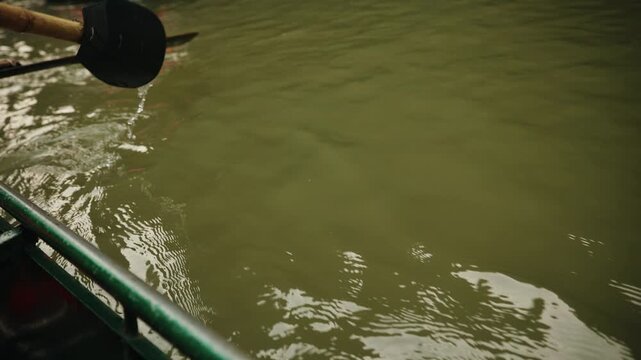 Boat ride on trang an waterways in Ninh Binh, Vietnam scenic landscape.