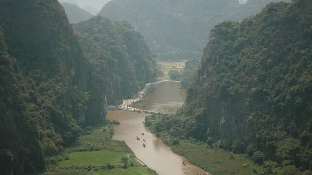 Stunning sunset over limestone mountains and river in Ninh Binh, Vietnam.