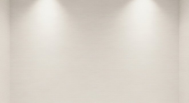 Textured white wall illuminated by warm overhead spotlights.