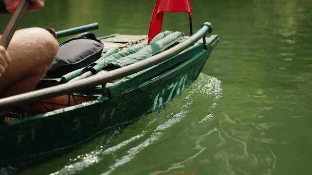 Boat ride on trang an waterways in Ninh Binh, Vietnam scenic landscape.