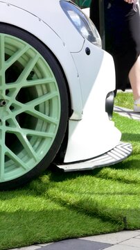 Close-up of a slammed car custom wheel with low profile tire tucked into the fender, stance tuning.
