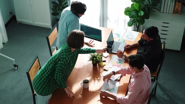 Top view of business people discuss idea while marketing team joining meeting. Manager pointing financial graph while colleagues talking to investor by using phone and brainstorm idea. Convocation.
