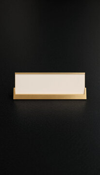 Minimalist gold and white nameplate on black background flat lay composition
