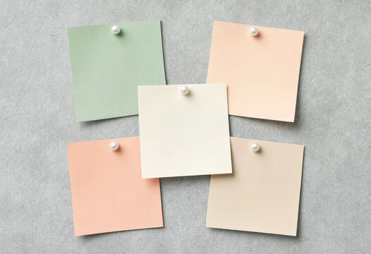 Five Pastel Sticky Notes Pinned on a Textured Gray Background, Flat Lay