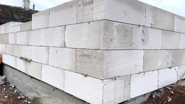 Building aerated concrete block wall on foundation for new home construction site