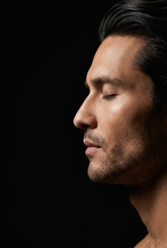 Side profile portrait of a man with closed eyes
