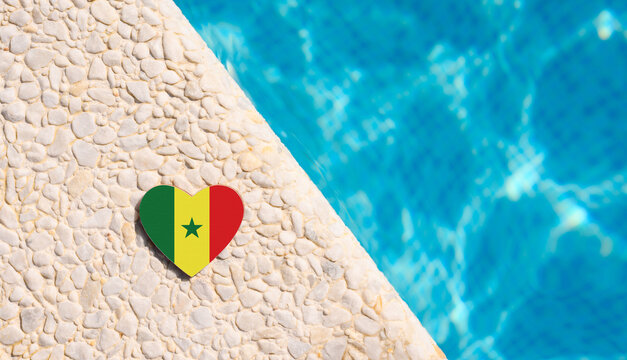 Senegal flag in the shape of a heart near the pool in the hotel.