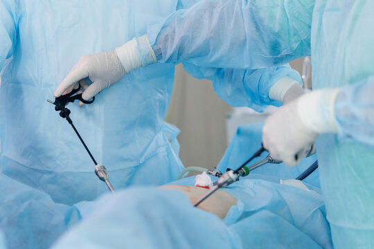Closeup Surgeons performing laparoscopic surgery in operating room