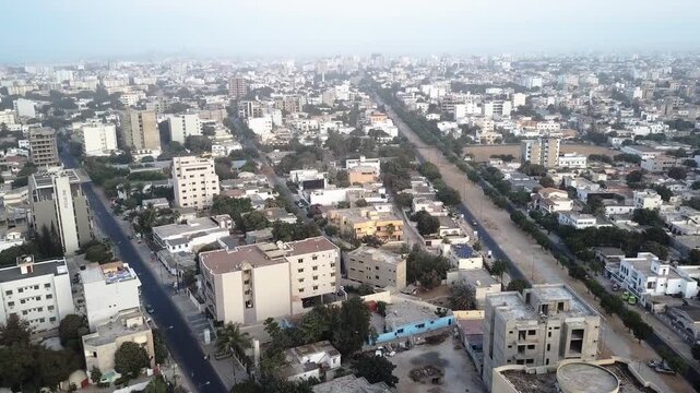 Aerial drone tilt up over hazy Dakar Senegal skyline