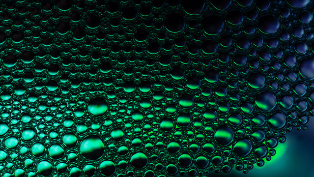 Green liquid bubbles forming an abstract pattern texture