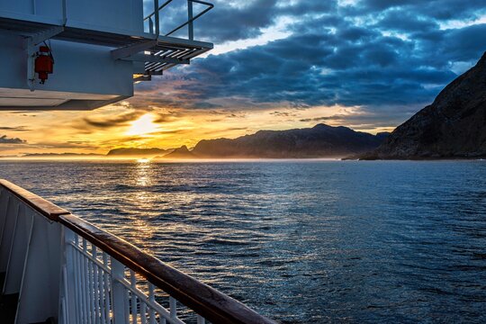 Landscape in Norway in beautiful sunrise light seen from a ship