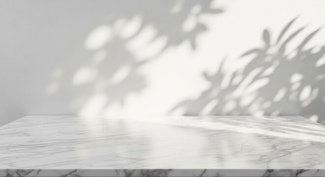 White marble surface with soft leafy tree shadows.
