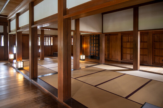 Interior view of a traditional Japanese room with tatami mat flooring and wooden pillars