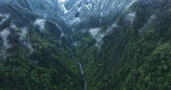Aerial footage of beautiful high altitude grassland and mountain landscape	