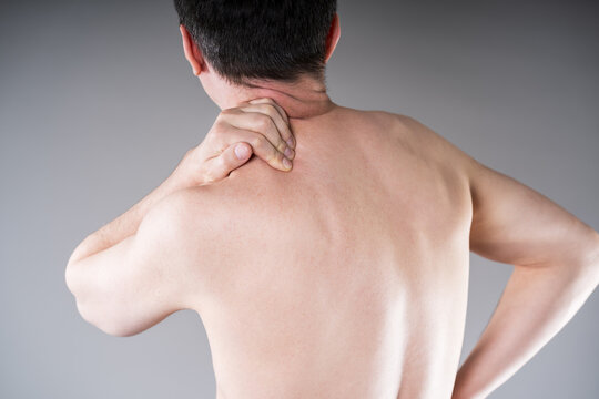 Man suffering from neck and shoulder pain. Massaging tense trapezius muscle. Office syndrome and backache medical concept