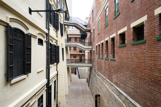 Historical brick and stucco buildings with connecting outdoor staircases at Tai Kwun in Central, Hong Kong