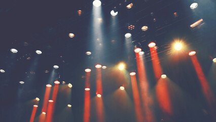 Fototapeta premium ceiling stage spotlights shines on a theater or Musical stage during the concert or show