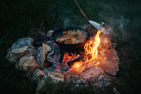 Outdoor cooking food on a rustic campfire
