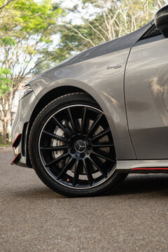 Grey Mercedes Benz A35 AMG front wheel close up outdoors, Luxury hot hatch black alloy rims and brakes