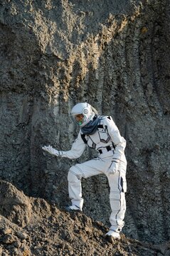 Exploration of the moon by an astronaut in a space suit on a rocky surface during daylight
