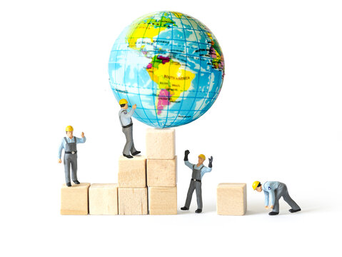 Miniature worker people with wood block isolated on white background.