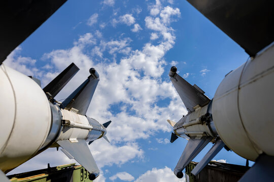 Two missiles aiming skyward showing military power and threat