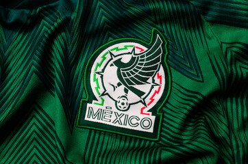 Naklejka premium Kyiv, Ukraine. June 16, 2026. Close-up of the Mexican national football team jersey featuring the official embroidered green and white crest.