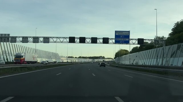 Amsterdam Netherlands highway, Urban highway entrance with moving traffic and sound barriers