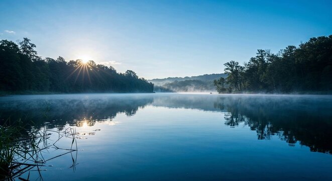 Serene river landscape at sunrise with morning mist and trees  