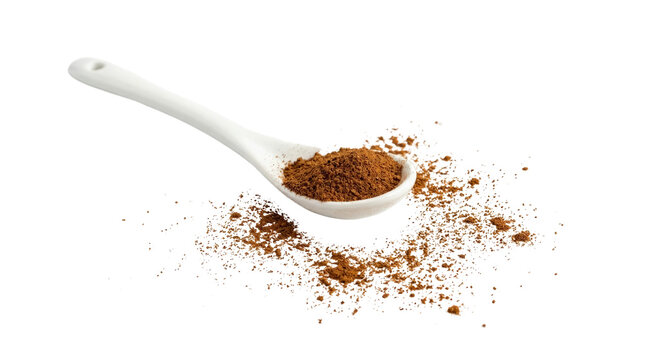 Close up of spilled coffee grounds on a white surface.