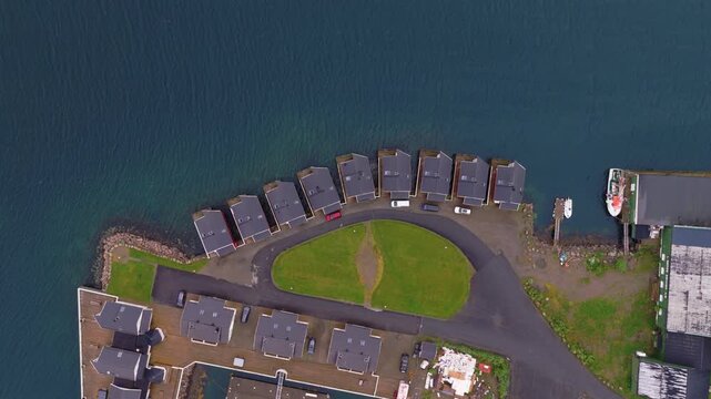Aerial view of coastal village with modern houses and harbor in Lofote
