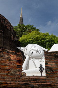 The Reclining Buddha at Wat Yai Chai Mongkhon, Ayutthaya, Thailand, is a sacred site for Buddhist pilgrims. This iconic statue represents Buddha's parinirvana.