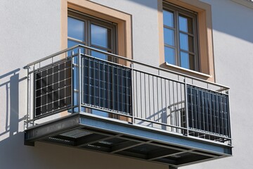 Obraz premium Modern apartment balcony with railings and sunlight