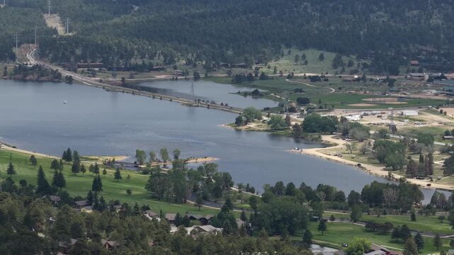 Summer aerial of Rocky Mountain National Park and forest in Estes Park with dense pine forest surrounding the water