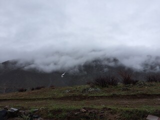Fototapeta premium Misty Mountain Landscape With Clouds Rolling Over Hills For Nature Backgrounds